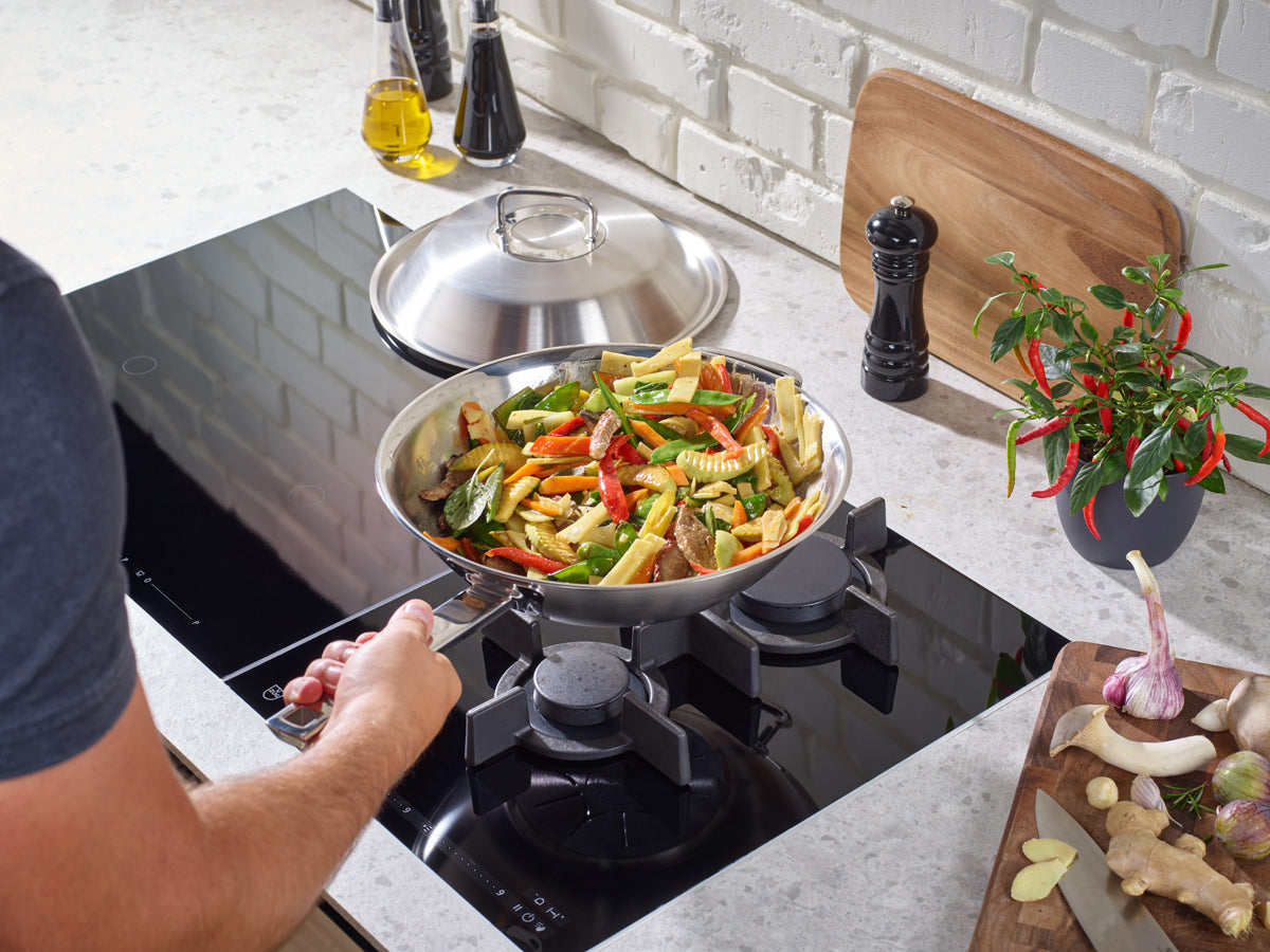 Cook a colorful wok dish with the Fissler Original-Profi Collection® Wok 30cm - precision, durability, and timeless German design.