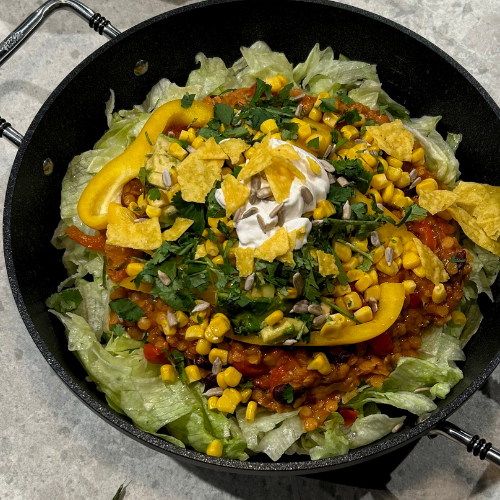 A taco salad served in an elegant black bowl, with fresh ingredients – perfectly presented with Fissler's precision and style.
