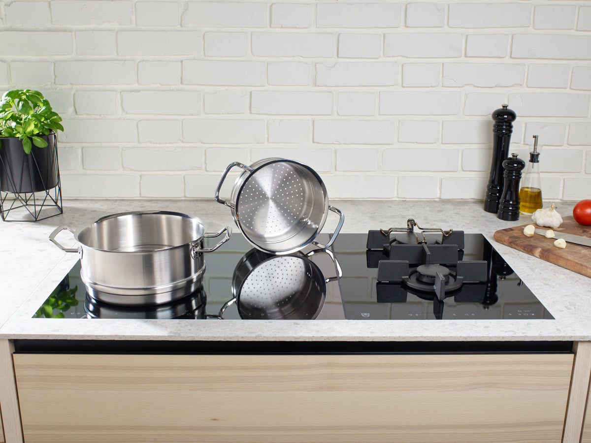Fissler Original-Profi Collection® Steamer insert in a simple kitchen, quality made in Germany, on the stove with fresh ingredients nearby.
